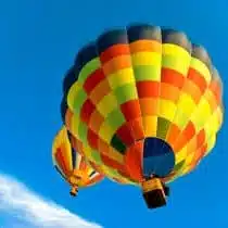 two hot air balloons flying in the blue sky